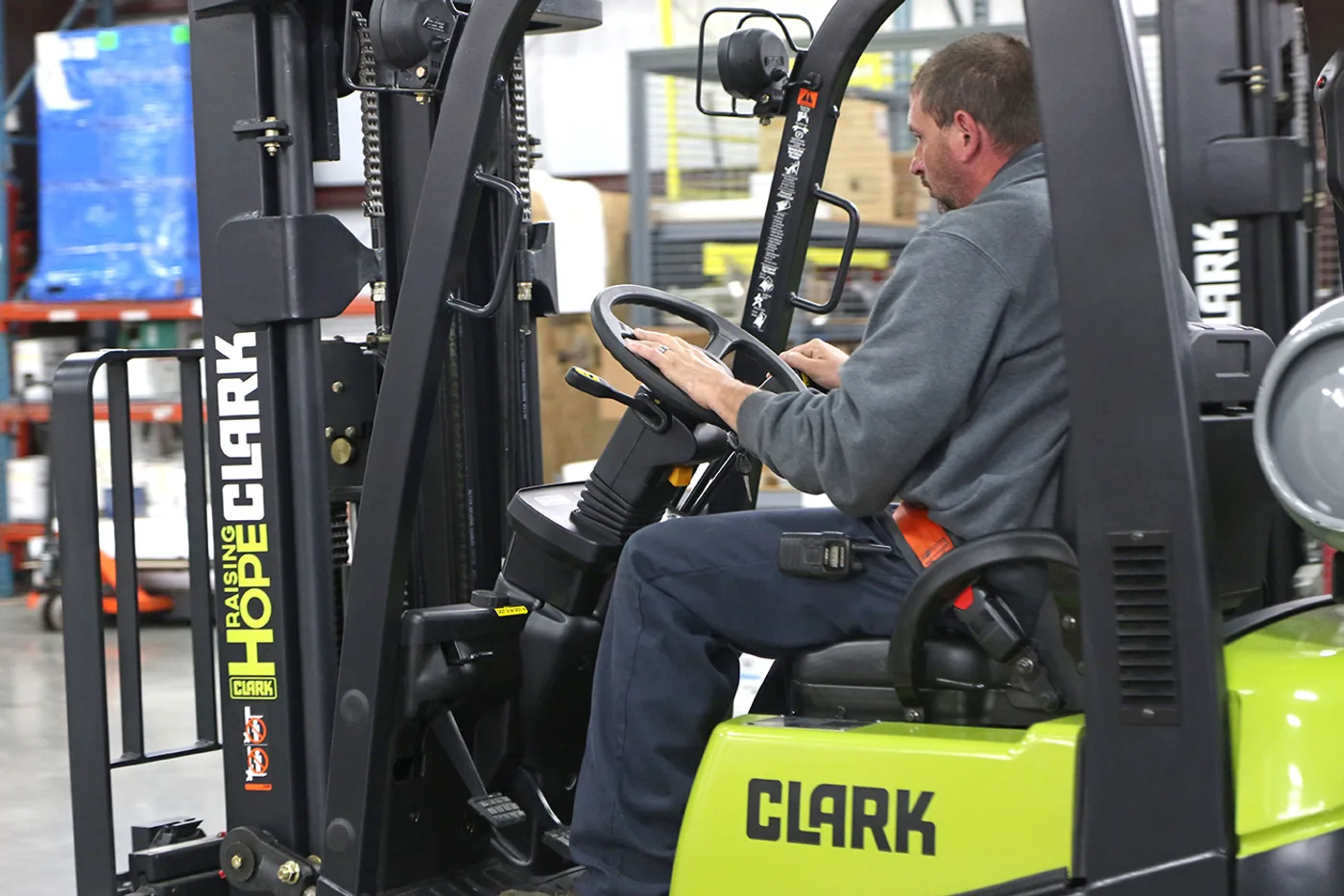 Operator at the controls of a new Clark C15C forklift in a Delaware warehouse