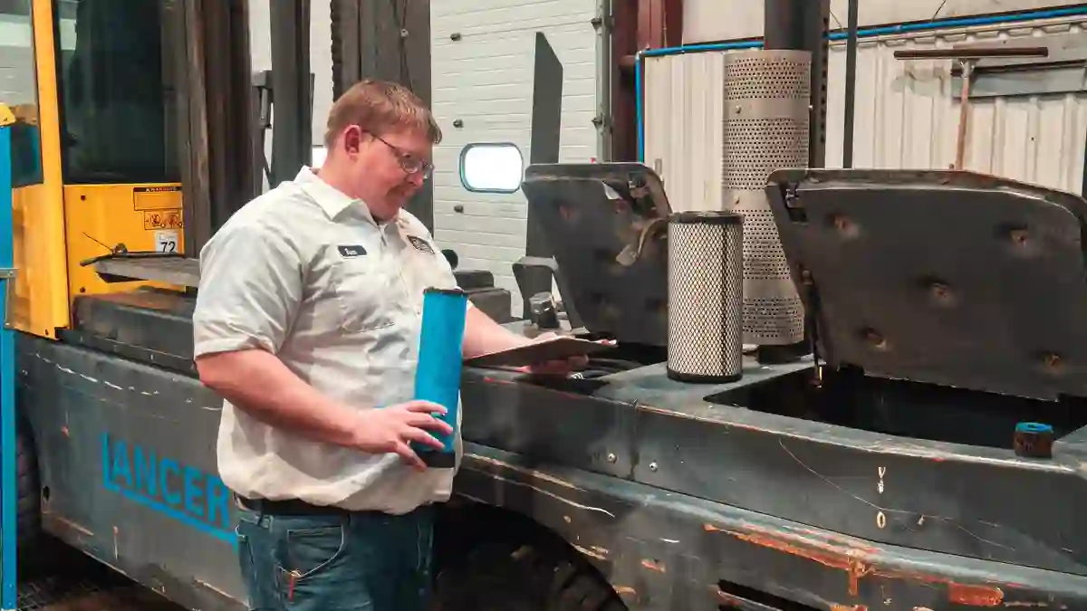 Forklift service and repair technician working on a lift truck in Delaware
